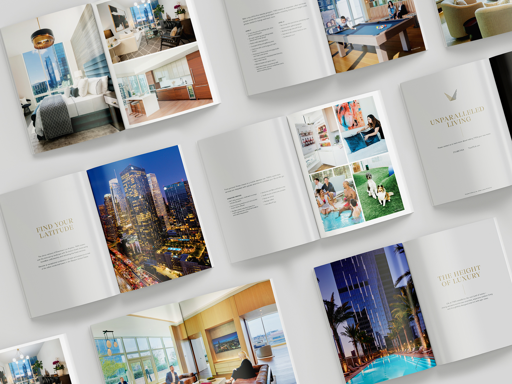 Multiple open brochures are arranged on a surface, displaying images of upscale interiors, cityscapes, pools, and lifestyle amenities with luxury-themed text.
