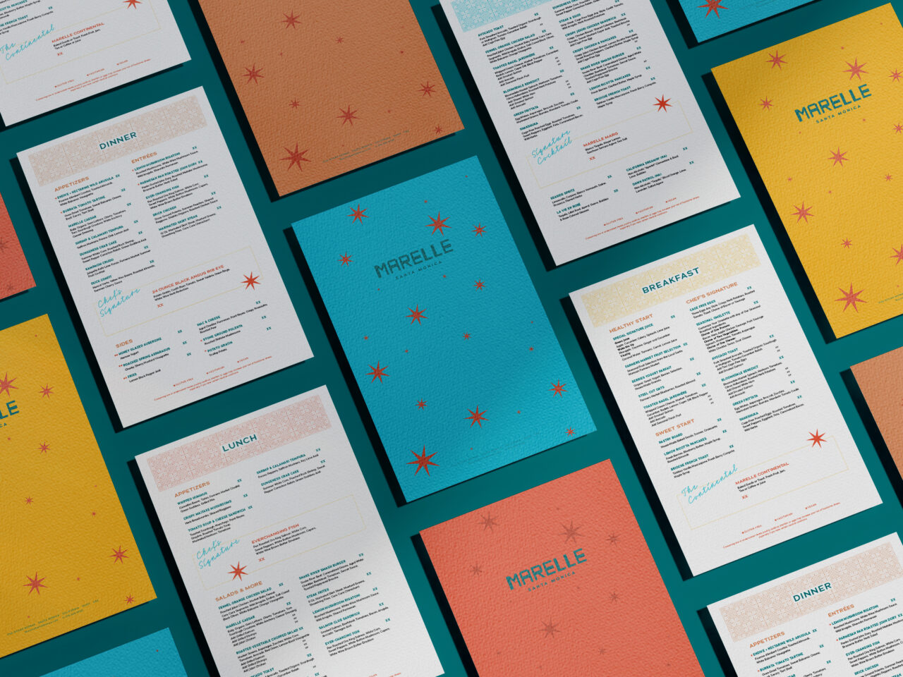 A flat lay of Marelle restaurant menus in various colors, including blue, yellow, and orange, displaying sections for breakfast, lunch, and dinner.