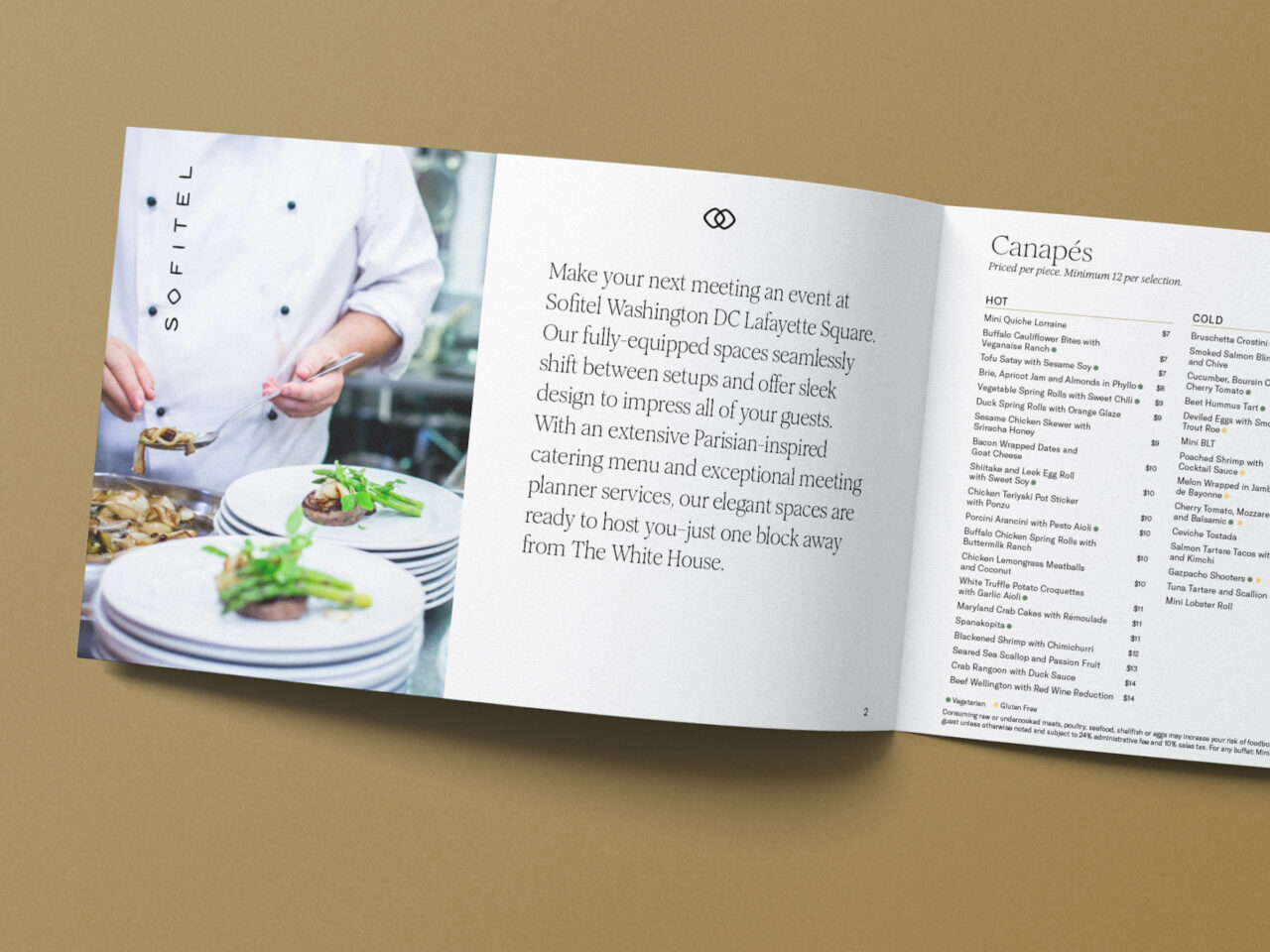 Open booklet on a tan surface showing a chef plating food on the left and event catering information with a canapés menu on the right.