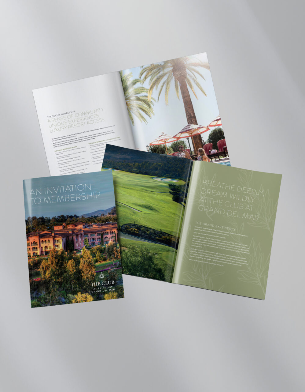Three open brochures on a light surface display images of a resort, golf course, palm trees, and text promoting club membership and luxury amenities.
