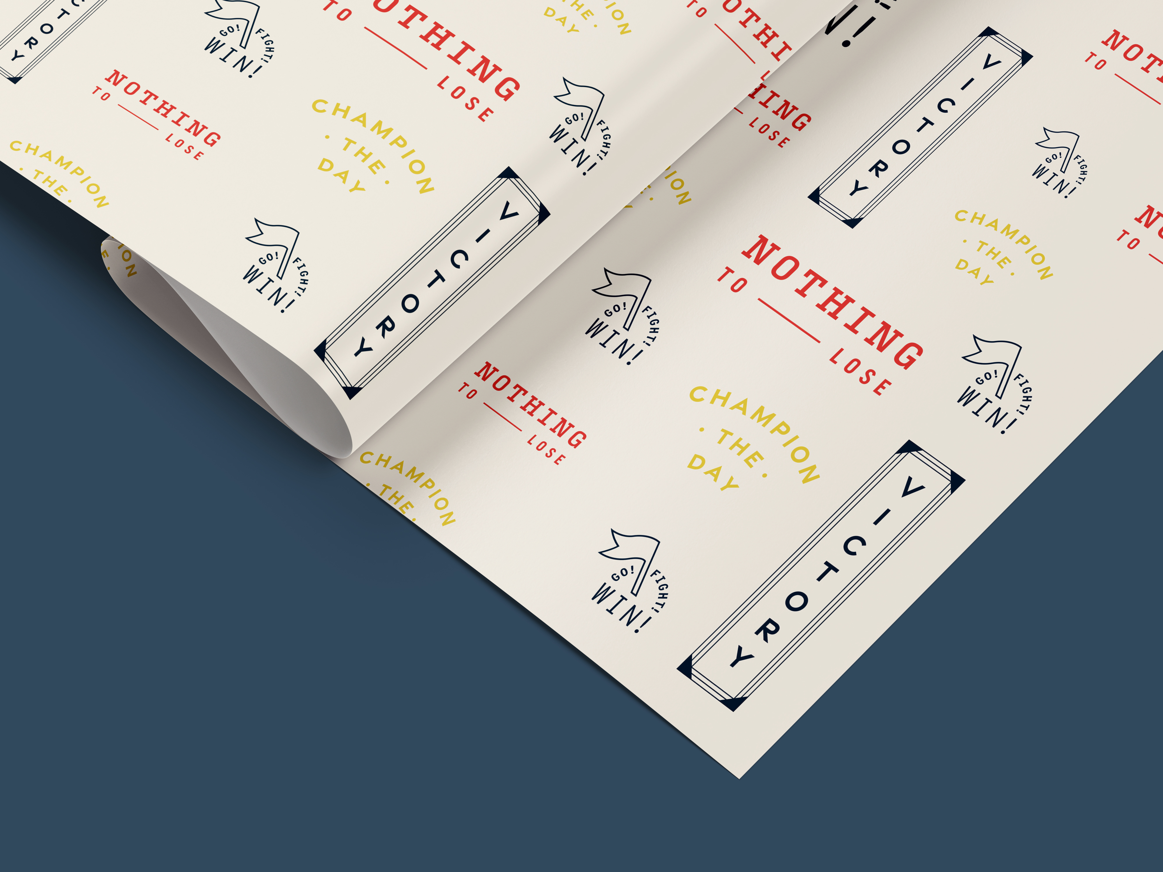 A sheet of patterned paper on a dark surface, featuring repeating motivational phrases such as "NOTHING TO LOSE", "CHAMPION OF THE DAY", "VICTORY", and "GO WIN!" with simple icons.