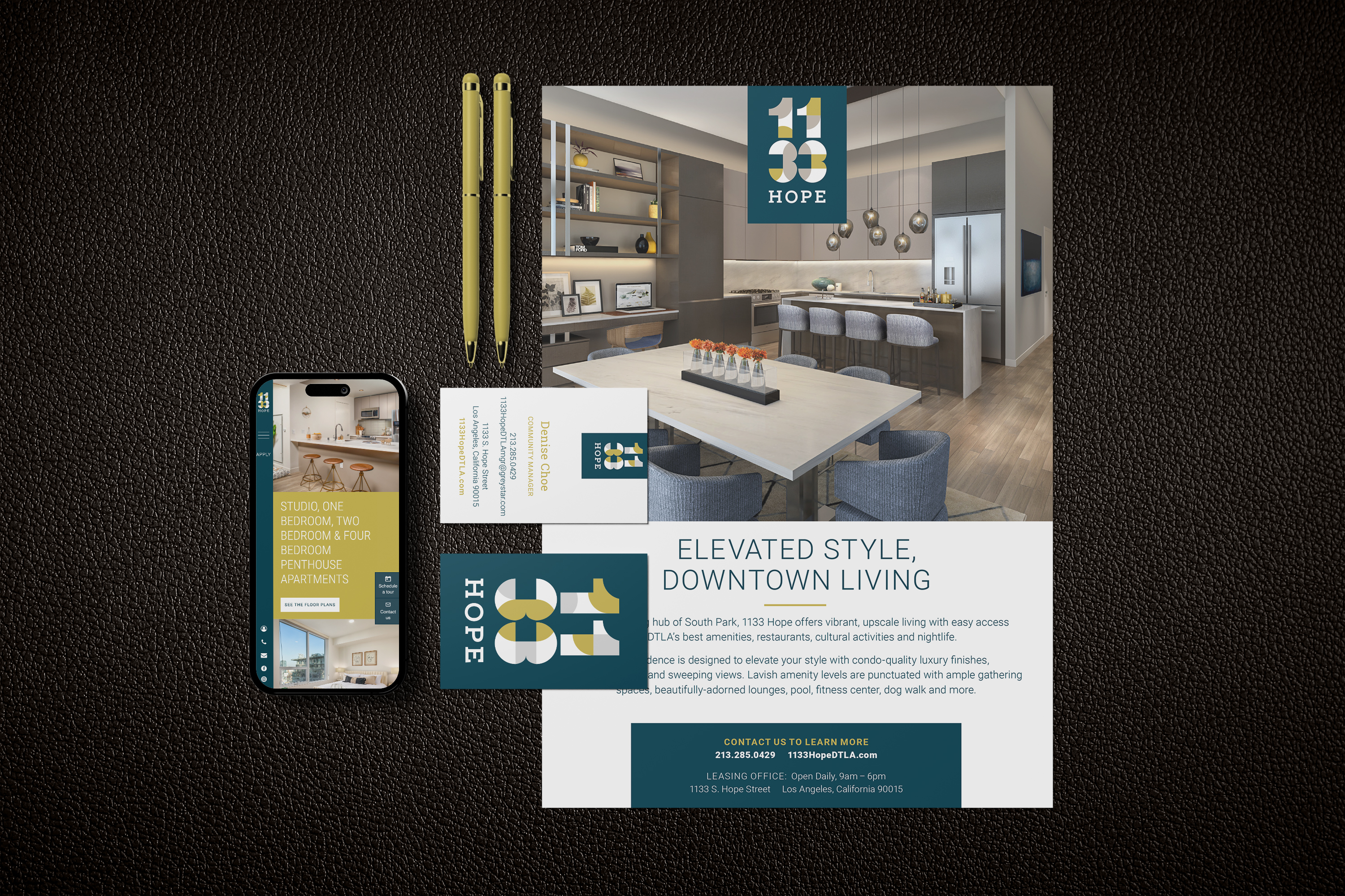 A flyer, business card, and smartphone display promote 1133 Hope apartments, featuring a modern dining and living area, branding, and contact information on a dark textured background.