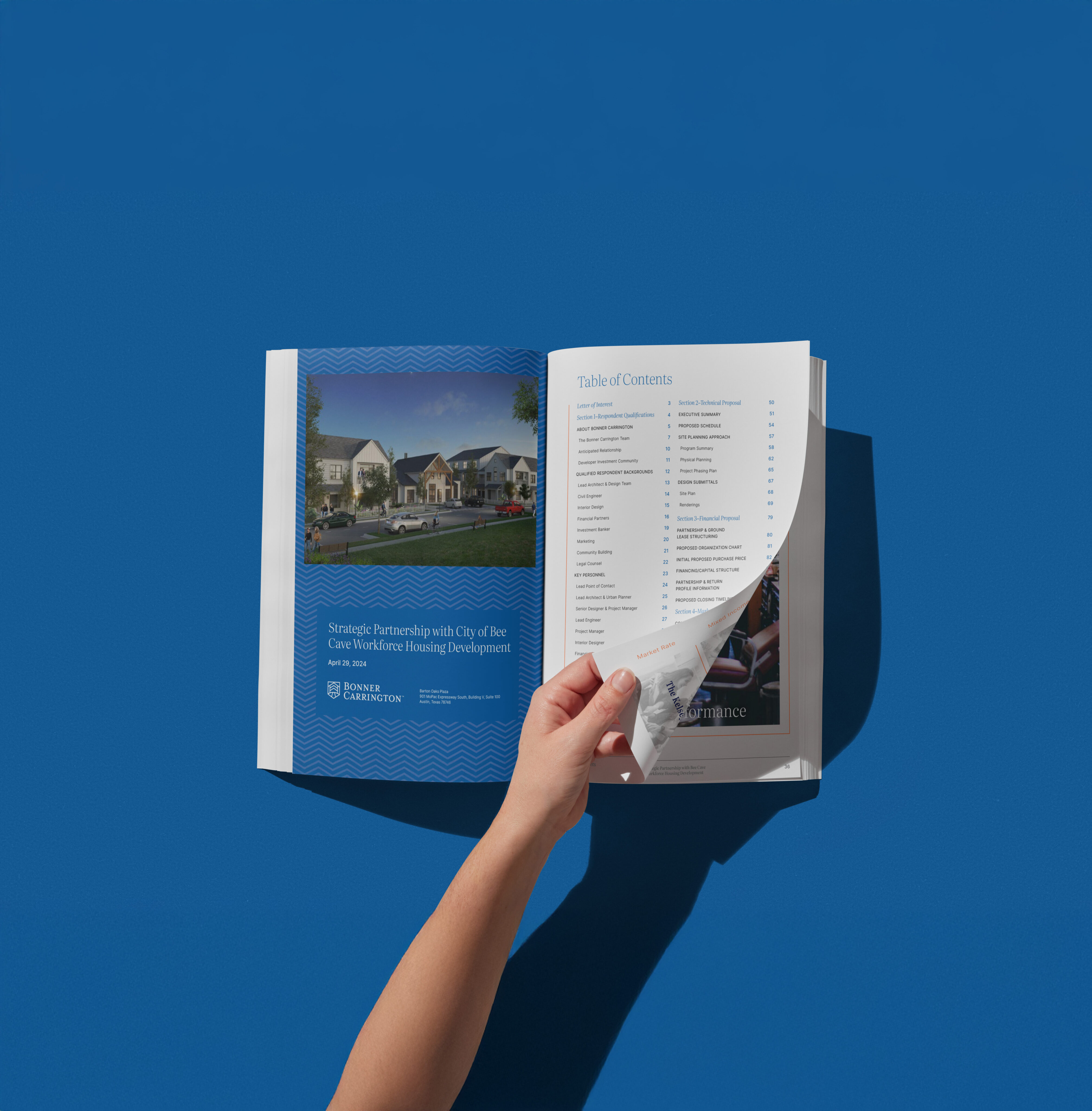 A hand flips a page of an open magazine on a blue surface, revealing the table of contents and an article about a city partnership for housing development.