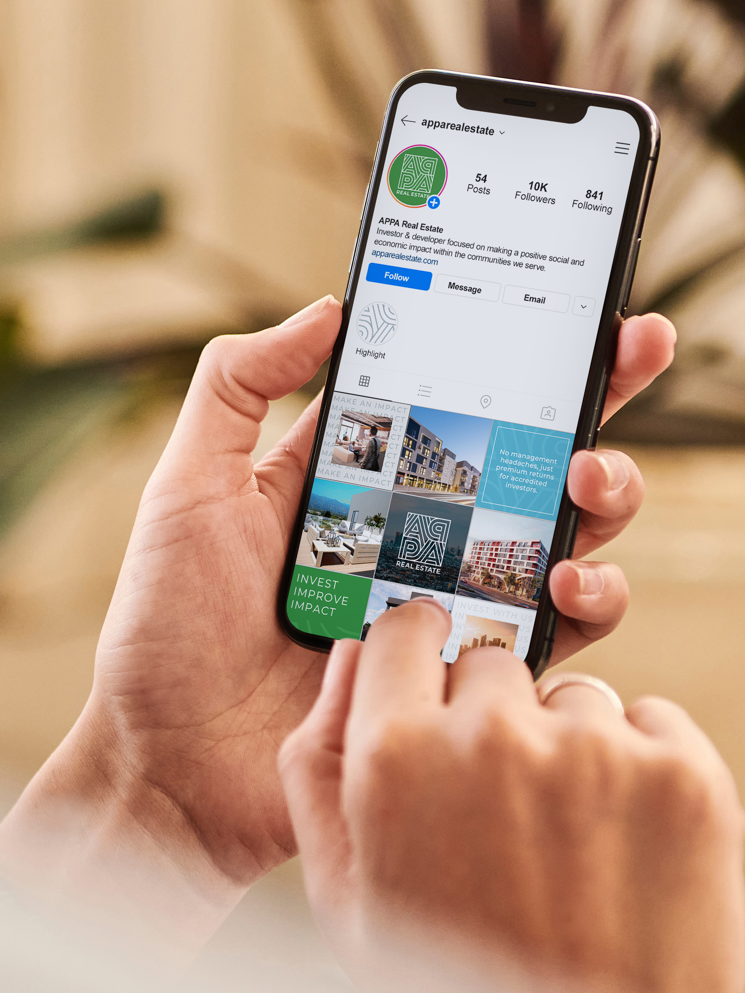A person holds a smartphone and browses an Instagram profile called "APPRL Real Estate" featuring property-related posts.