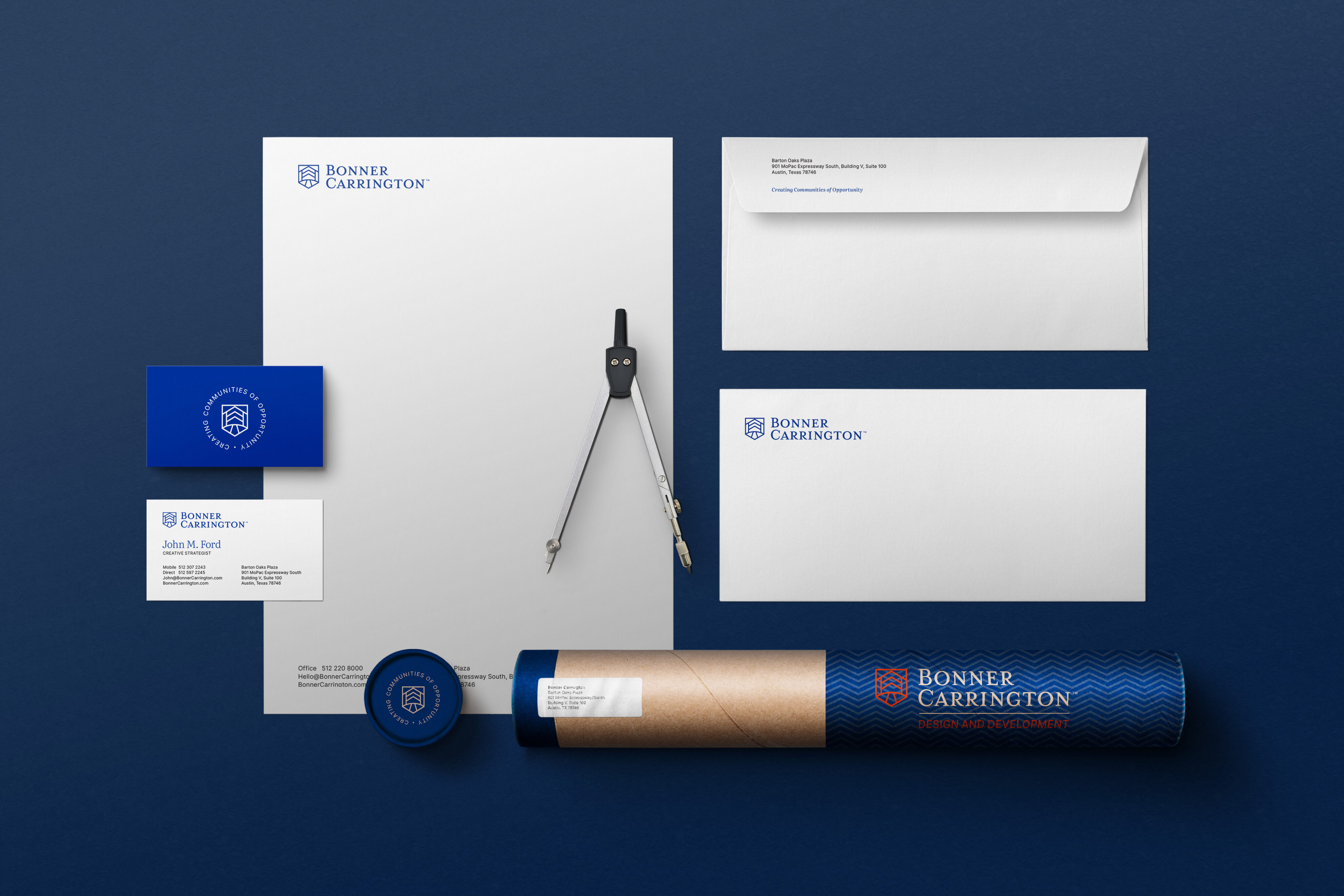 A set of branded stationery for Bonner Carrington, including letterhead, envelopes, business cards, a mailing tube, and a compass, displayed on a dark blue background.