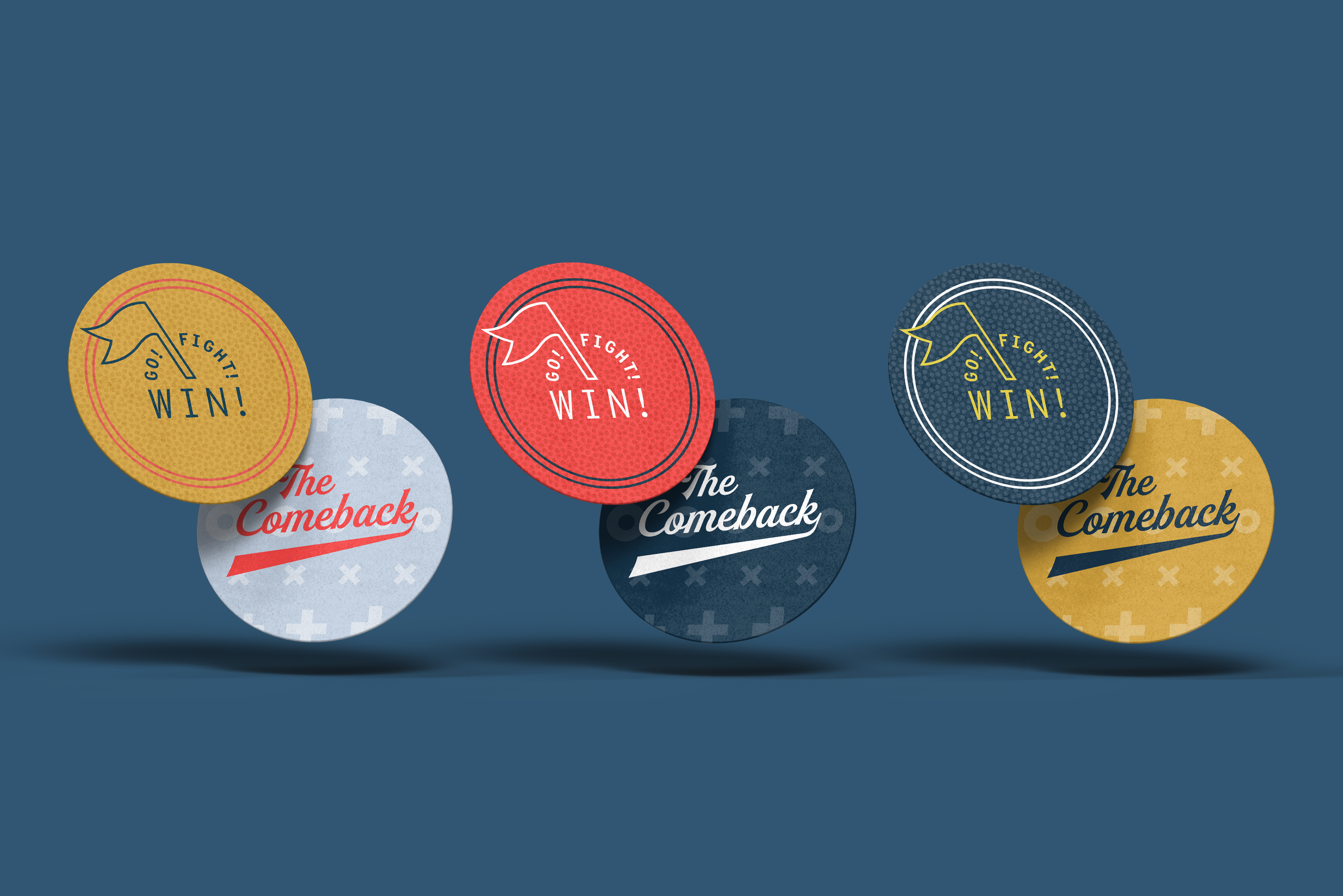 Four circular tokens are shown in pairs, each with the phrases “Go! Fight! Win!” or “The Comeback” in various colors and styles, displayed against a blue background.