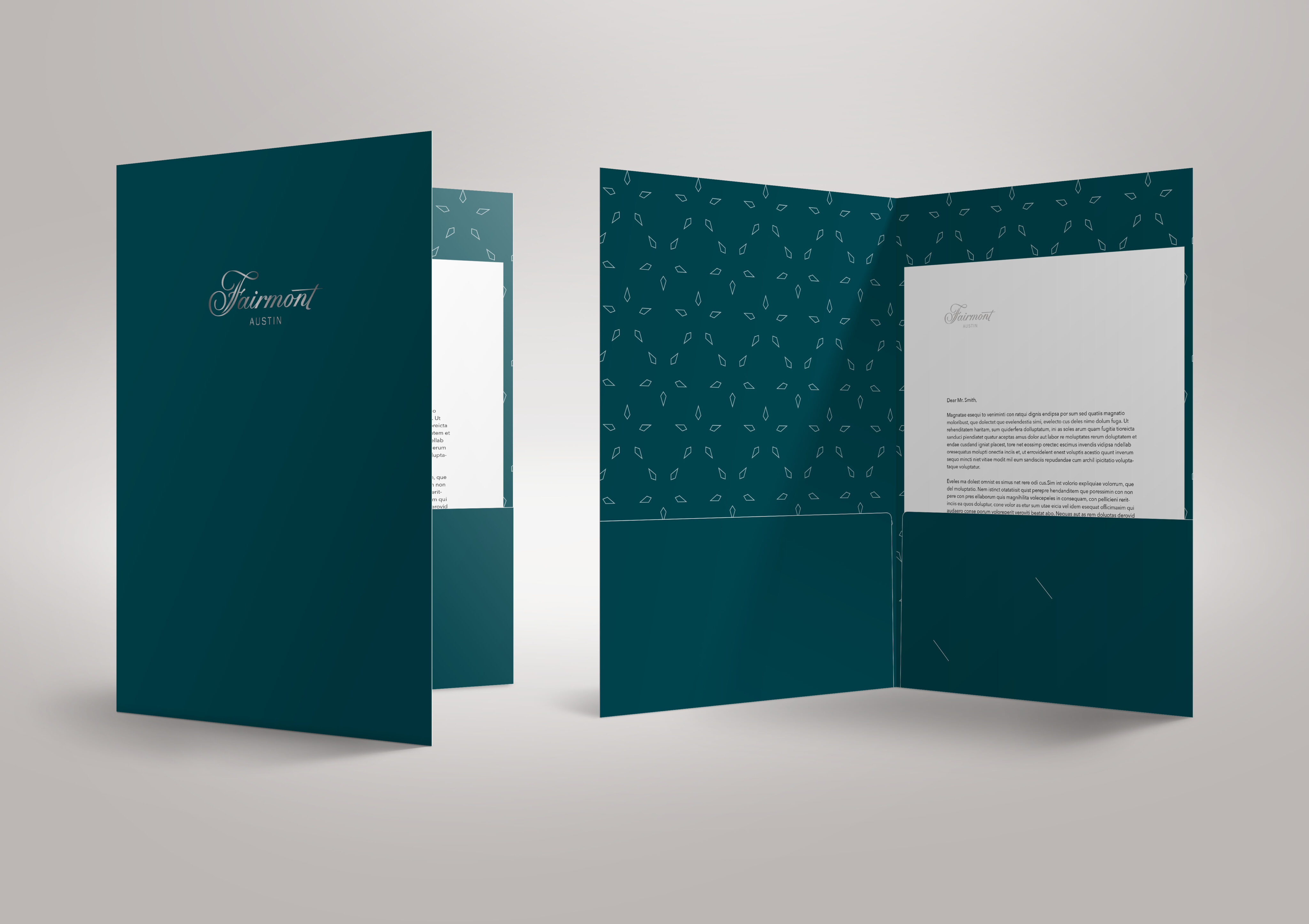 Two dark green presentation folders with Fairmont Austin branding are shown, one closed and one open displaying documents inside.