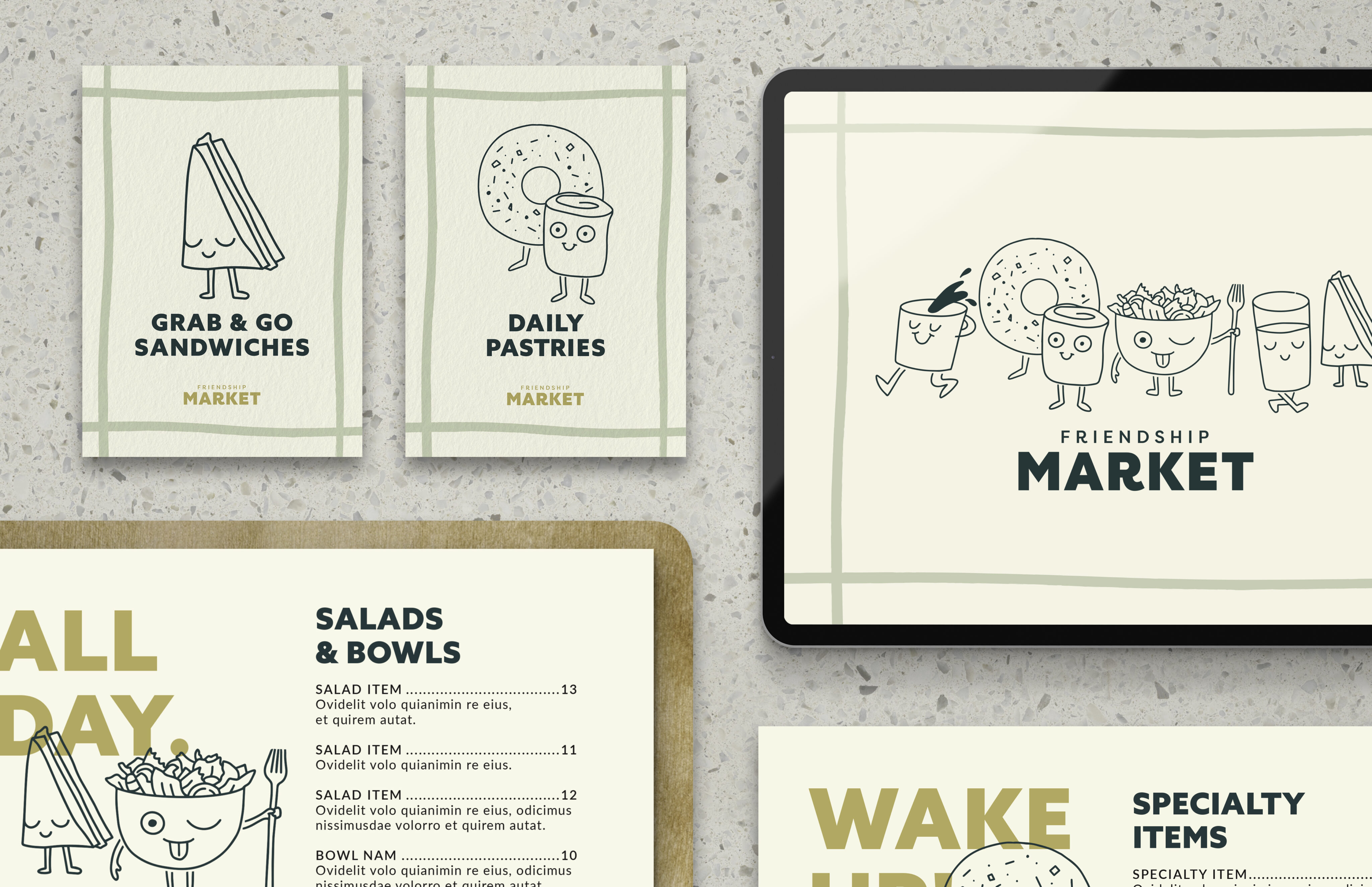 A set of illustrated market menus and signs featuring smiling food characters, including sandwiches and pastries, displayed on printed cards and a tablet on a speckled surface.