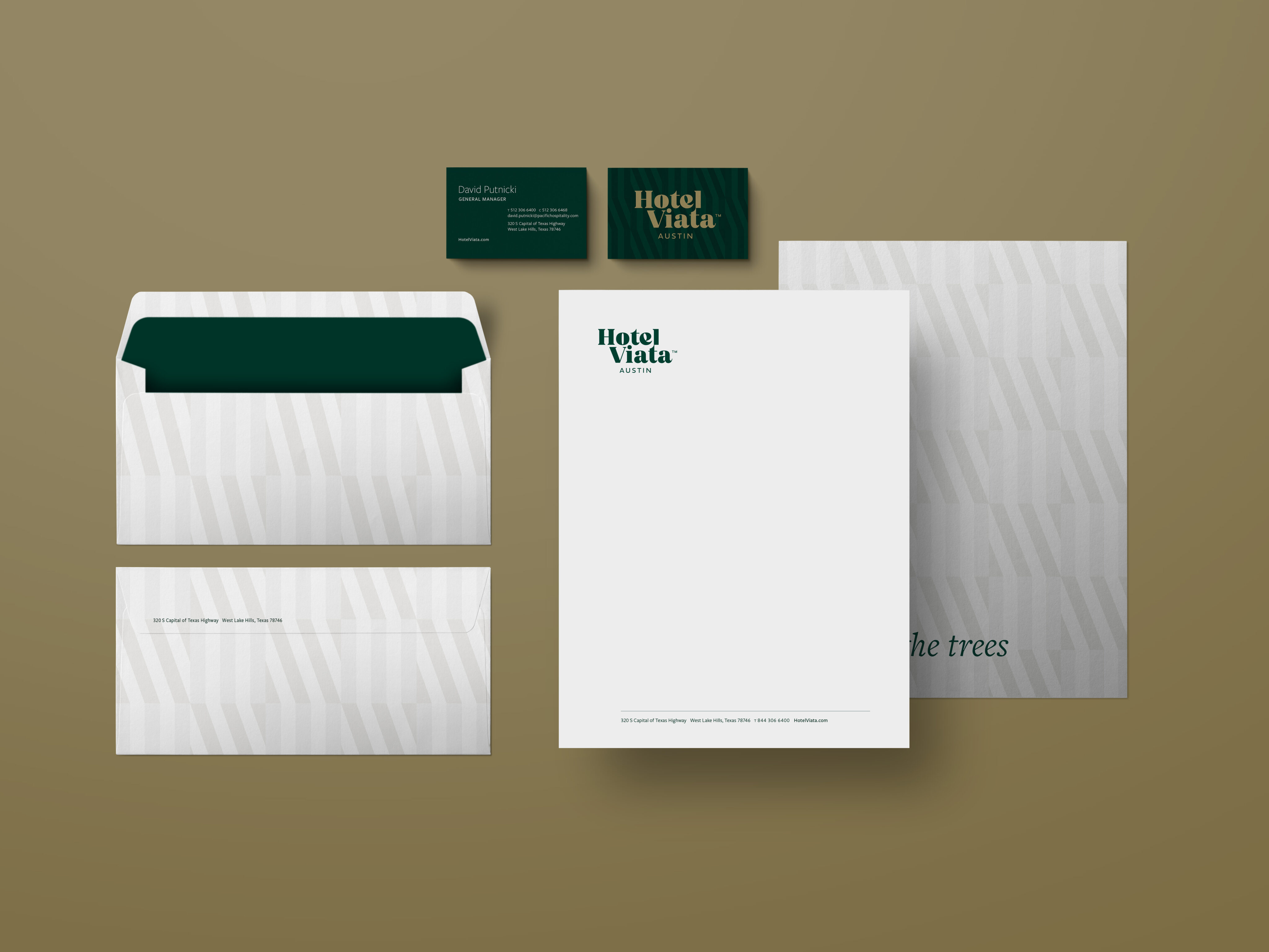 Stationery set for Hotel Viata displayed on a beige surface, including an envelope, business cards, letterhead, and document with green and white branding.