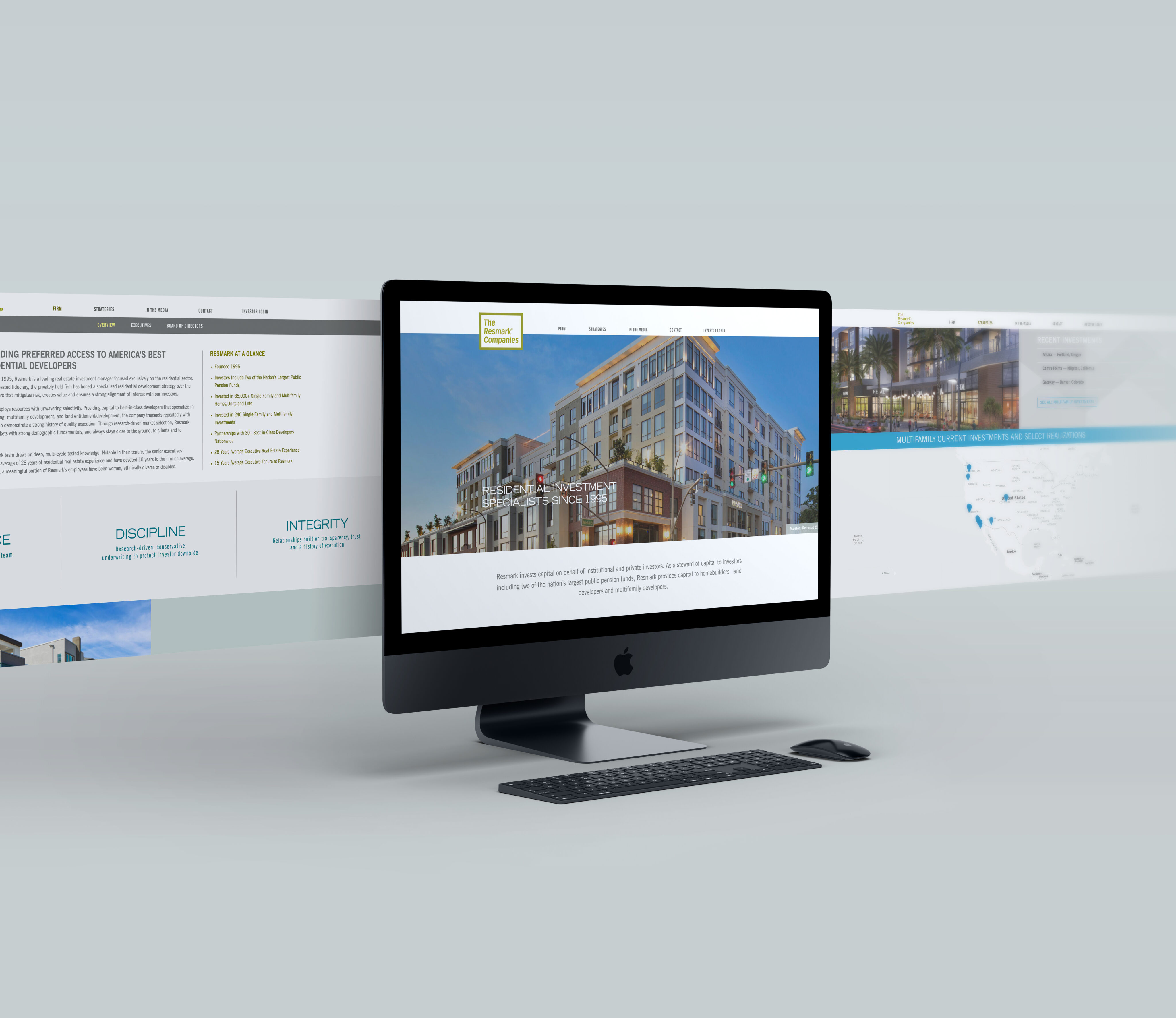 A desktop computer on a light desk displays a real estate website, with extended website interface graphics shown in the background.