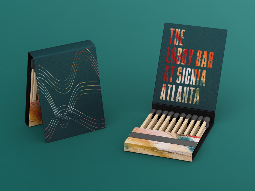 Two open matchbooks on a teal background; one shows abstract line art, the other reveals colorful text reading, "The Lobby Bar at Signia Atlanta.