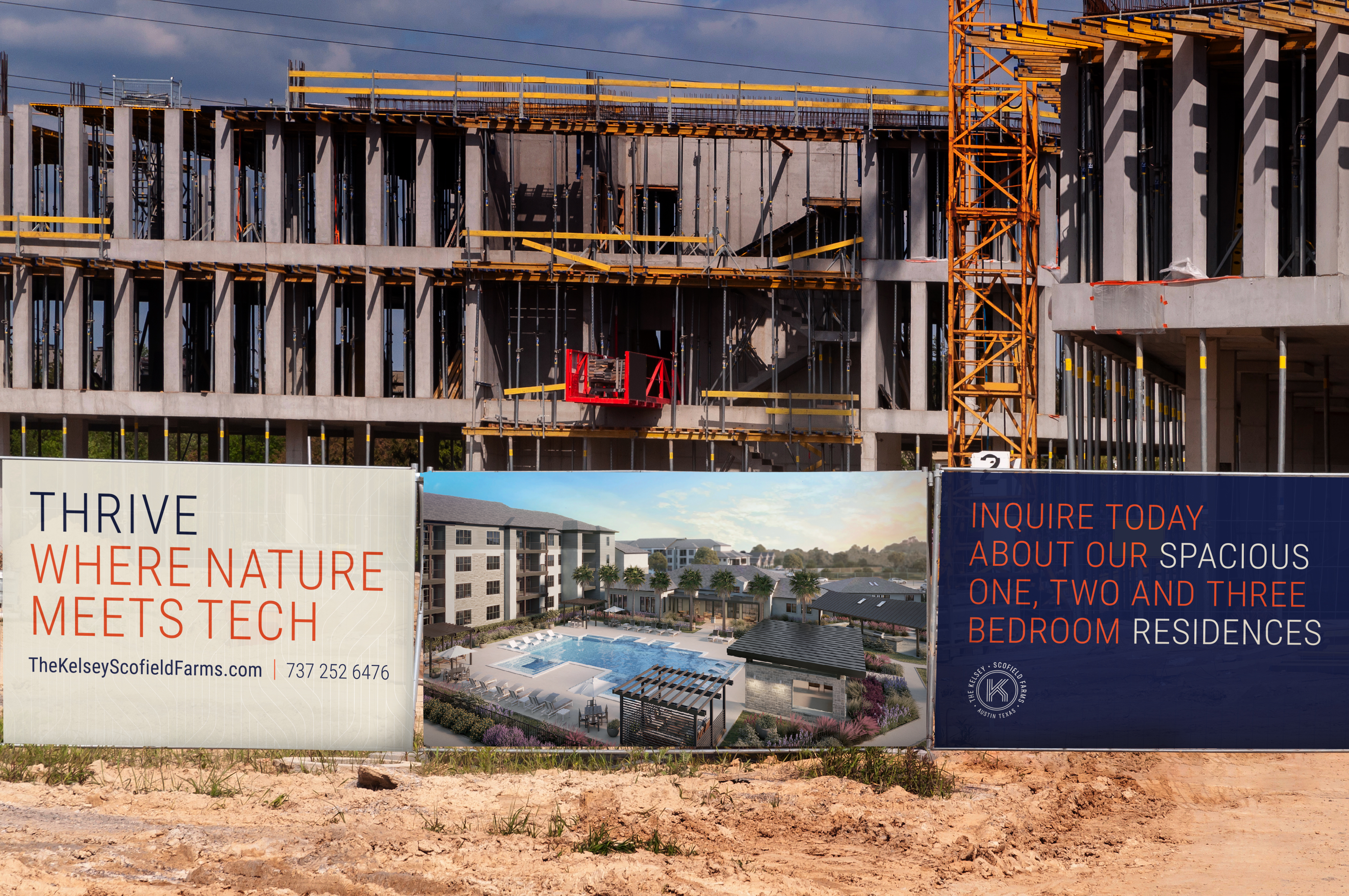 A construction site with banners advertising new residences, featuring a pool rendering and contact information beside an unfinished building with scaffolding and cranes.
