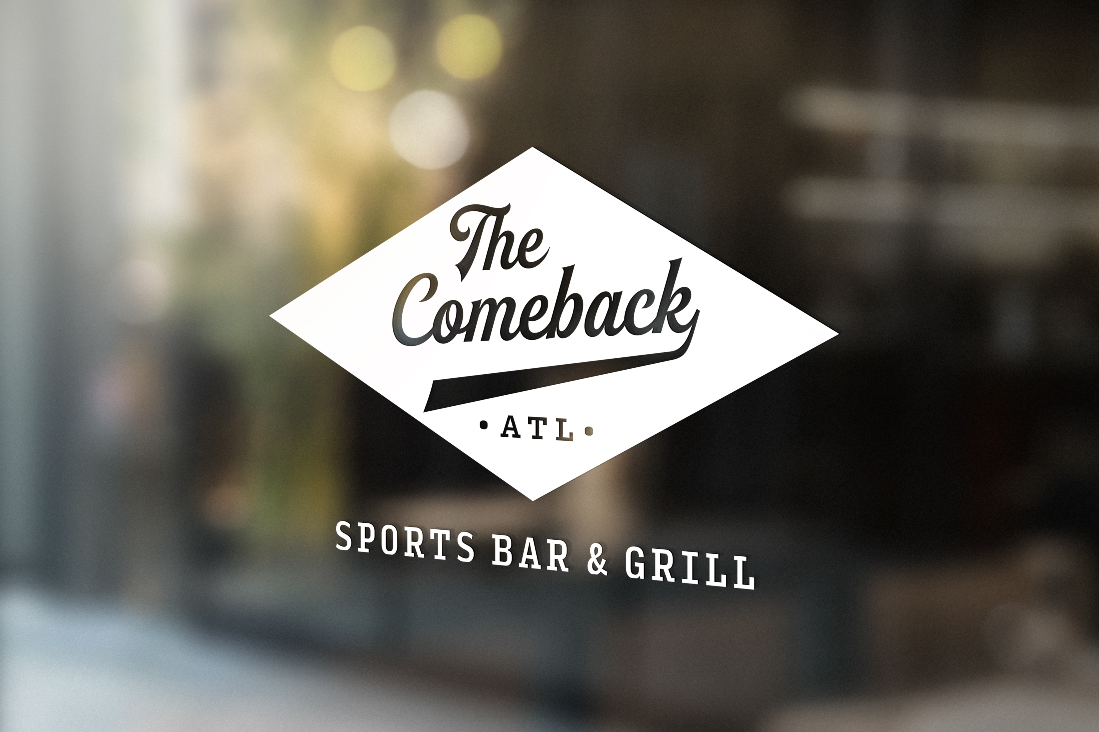 Logo for "The Comeback ATL Sports Bar & Grill" displayed on a glass window, with blurred lights and indoor setting in the background.