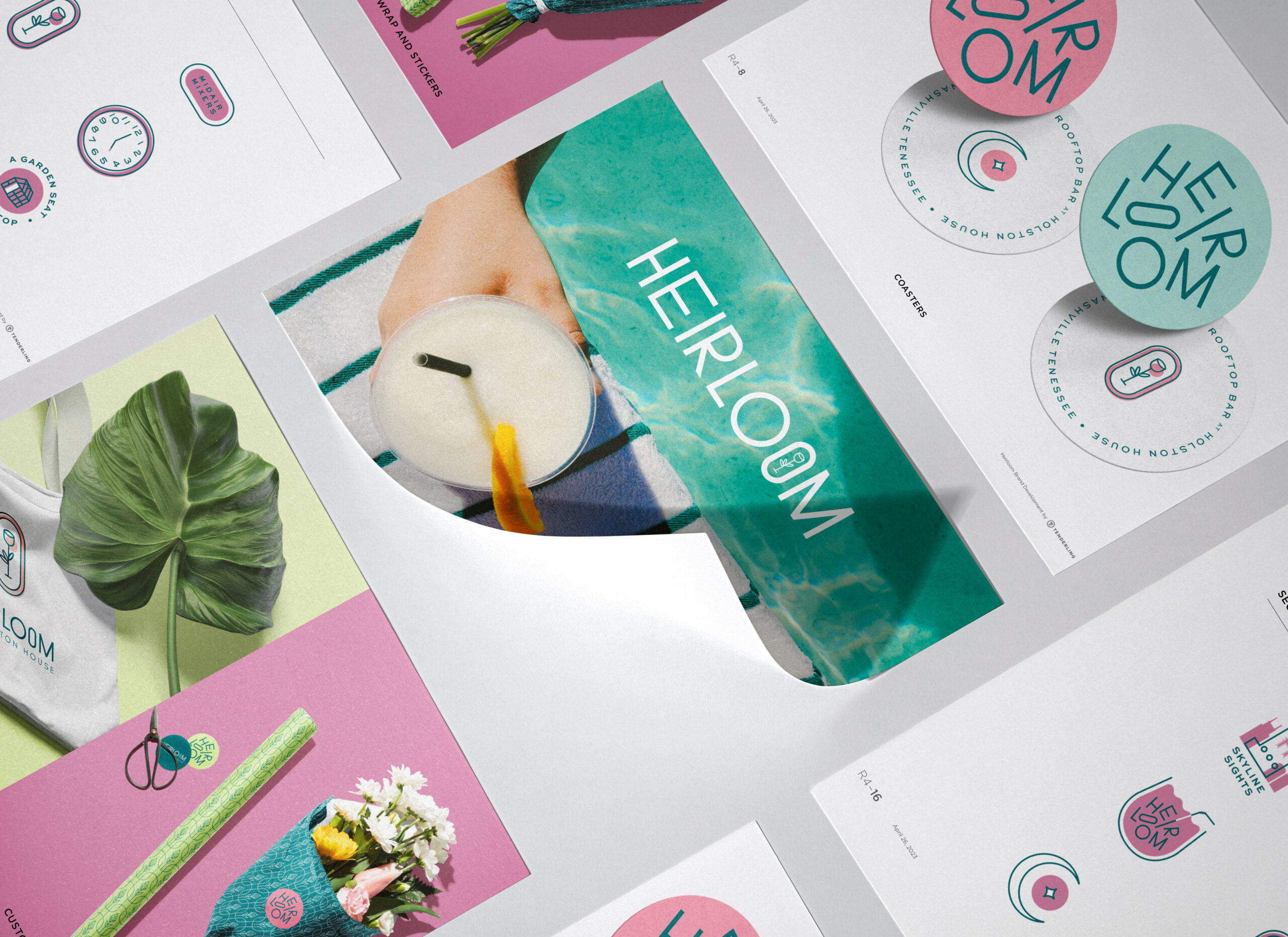 A flat lay of branding materials for "HEIRLOOM" featuring printed cards, stickers, a cocktail, a leaf, and colorful graphics in pink, green, and white tones.