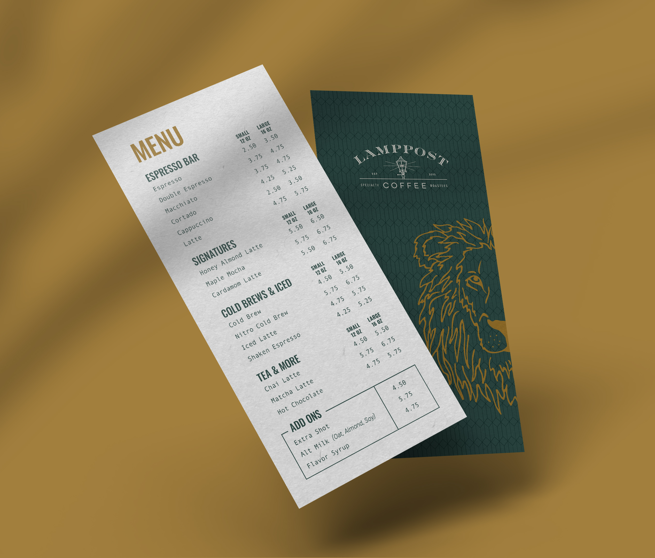 Two vertical coffee shop menu cards on a brown surface; one shows a lion illustration and logo, the other lists espresso drinks, teas, cold brews, and add-ons with prices.