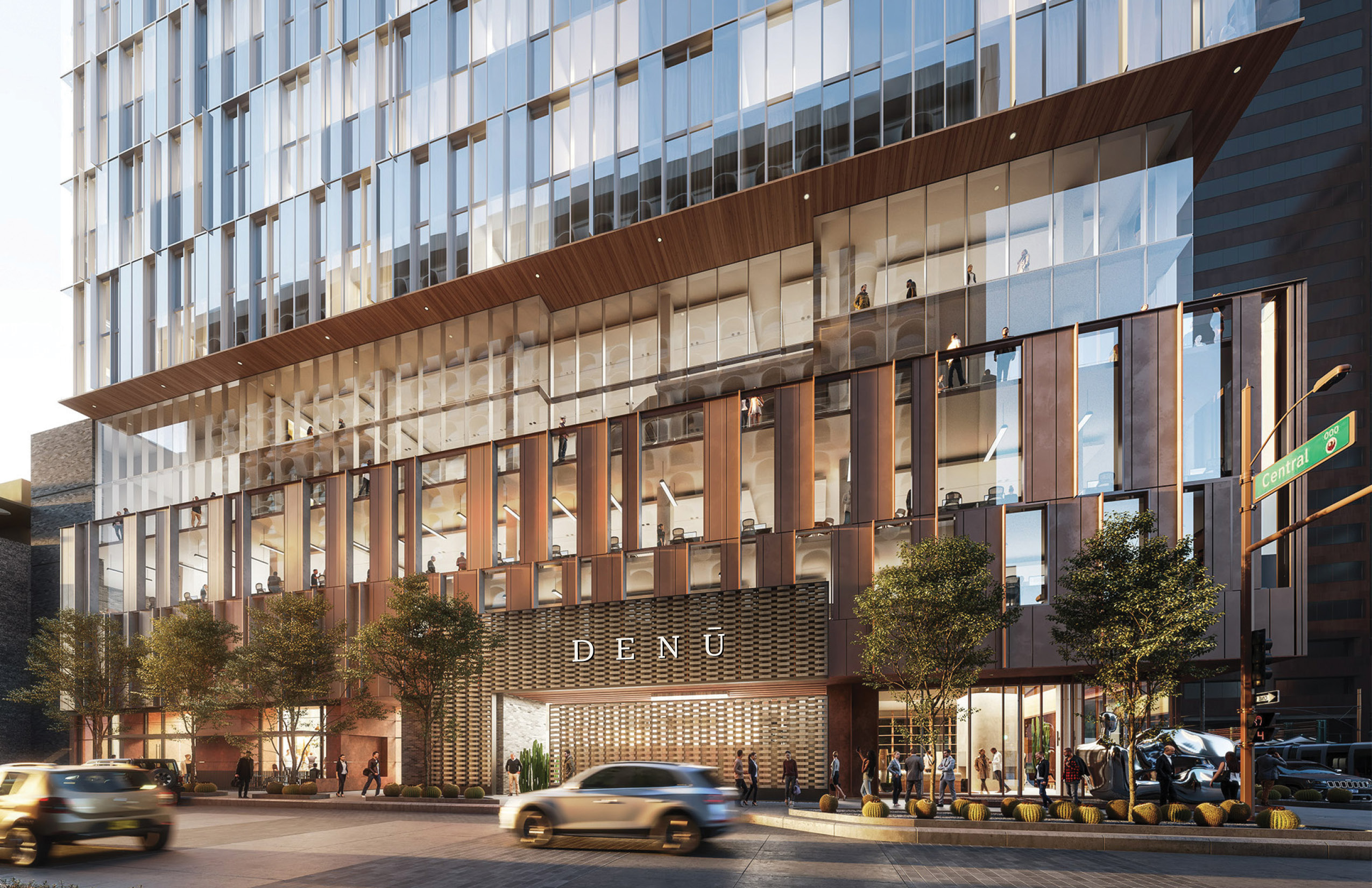 A modern glass office building with "DENÚ" on the entrance, street traffic, pedestrians, and trees outside.