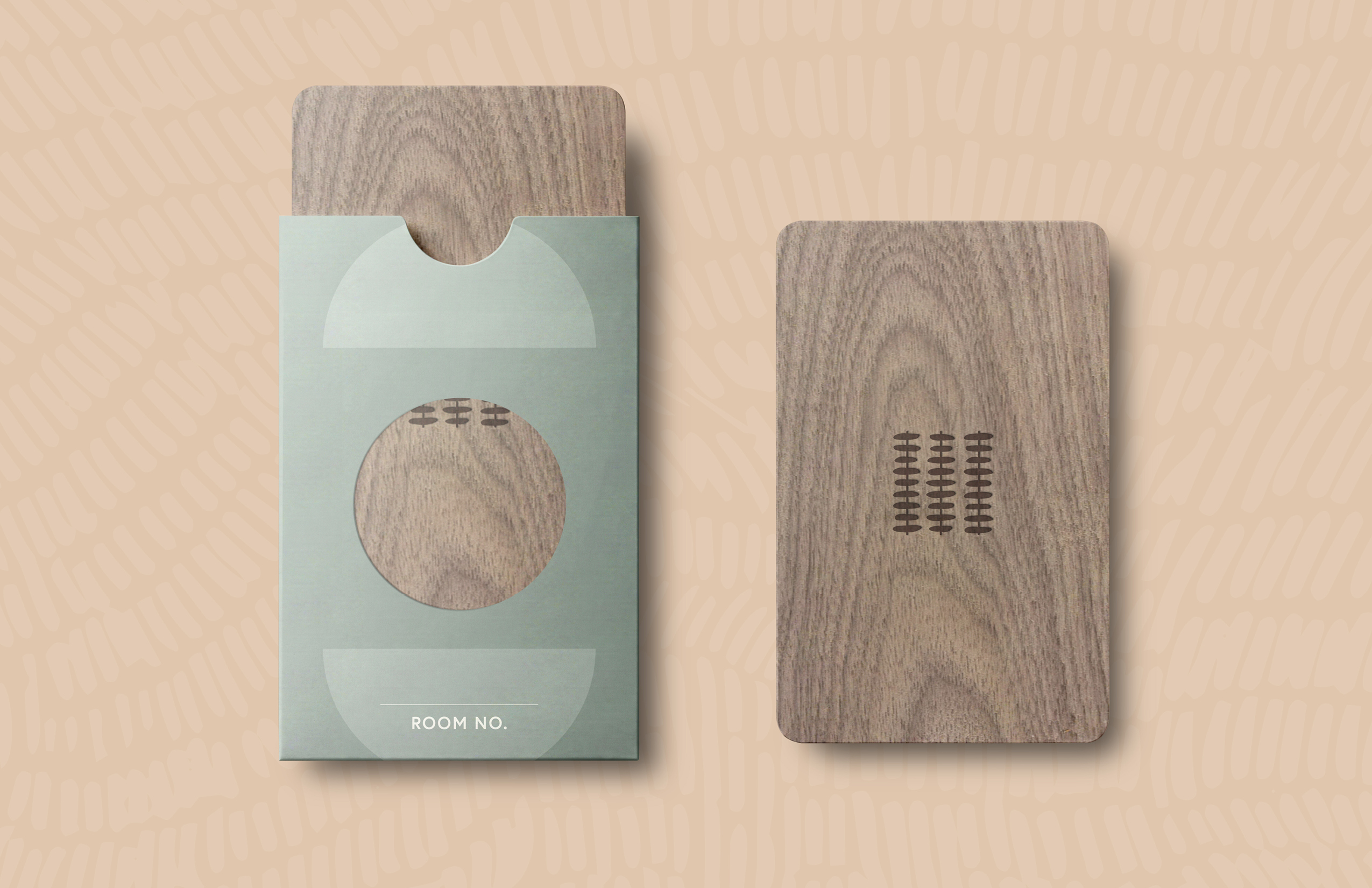 A wooden card partially inside a green sleeve with a round cutout; another card is placed next to the sleeve, both featuring a small engraved pattern.